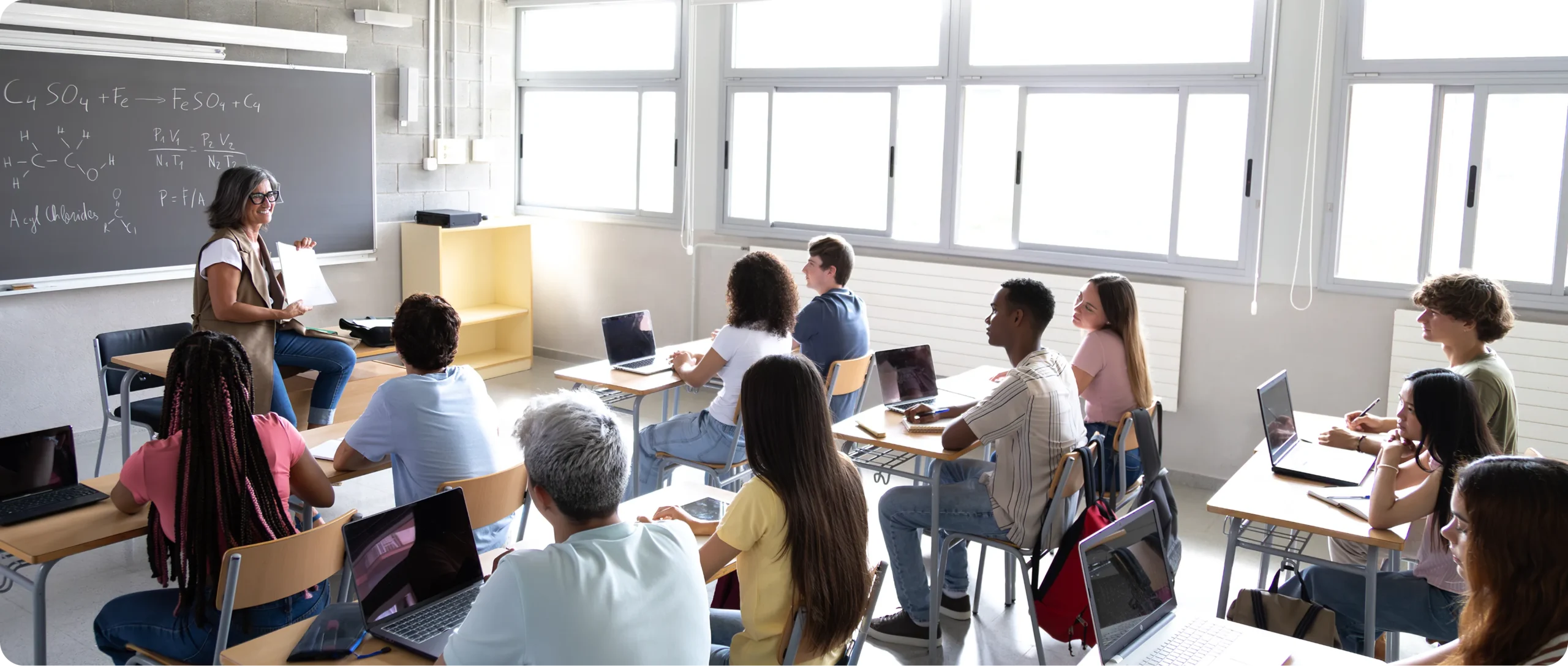 Teacher engaging students during lesson in classroom