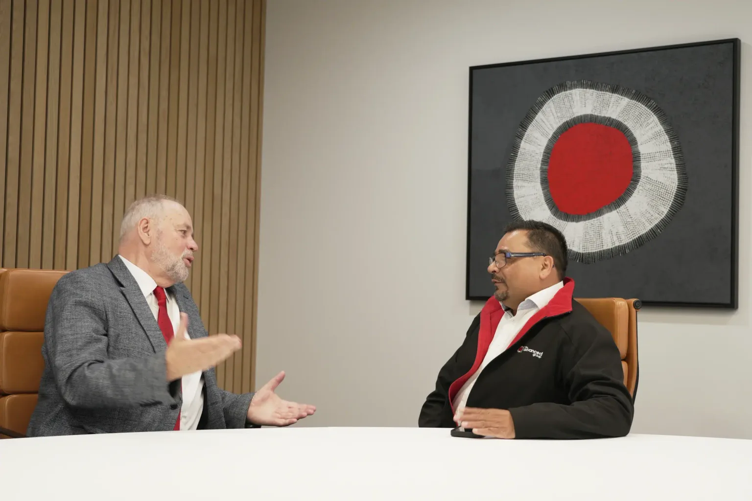 Advanced Group team members in a boardroom discussion